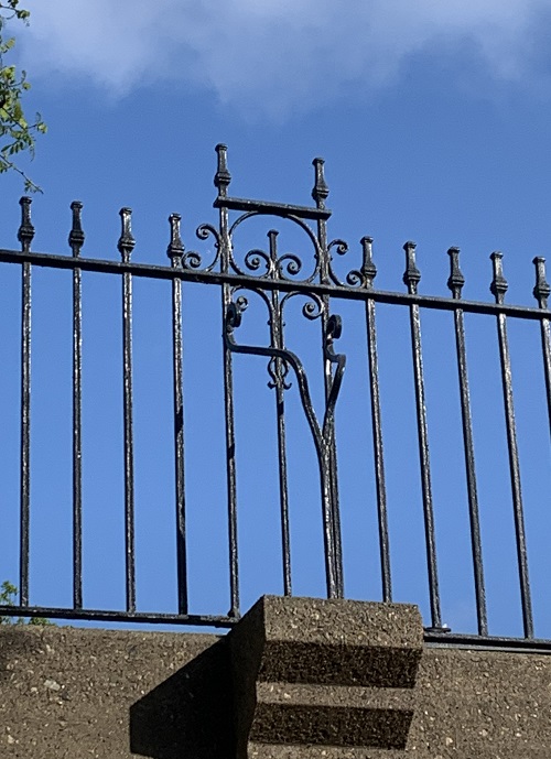 photo of iron railings with a curly pattern.